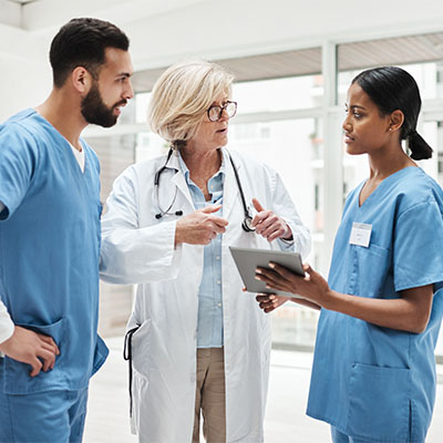 Altus medical team consulting around a tablet